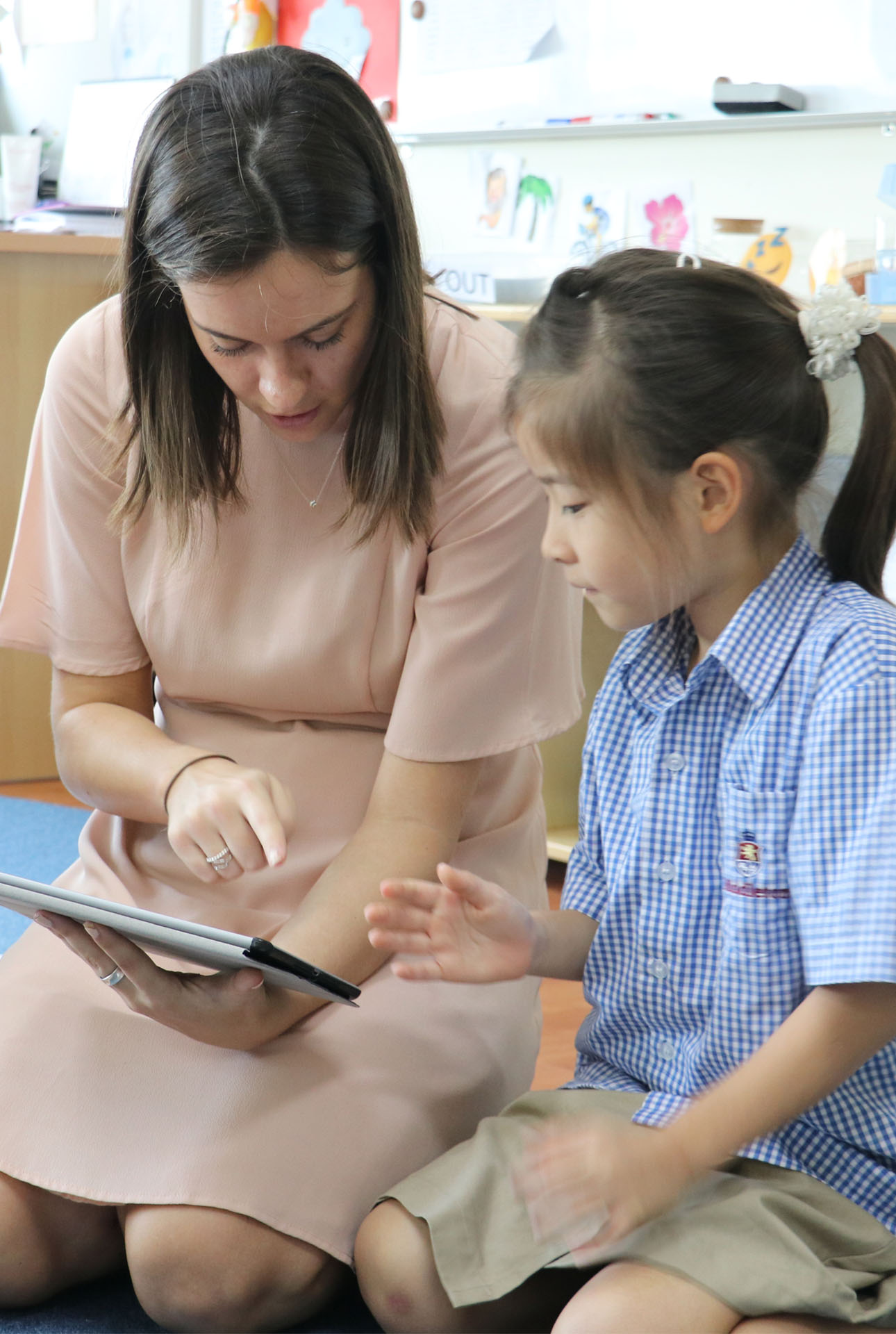 language Teacher reading with student